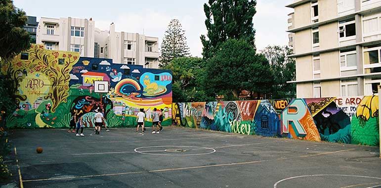 Mural at back and along side of basketball court.