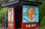 Bus shelter: woman on side with long red hair wearing a head-dress.