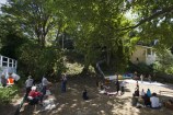 People sitting in the shade of trees at the Flagstaff Hill Park.