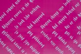 Close up image of the bright pink Civic precinct wall showing the text which is a poem saying: As we moved toward nine o'clock adjusting faces in the mirror, to look like nothing had happened... 