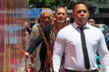 People walking alongside the civic precinct hoarding