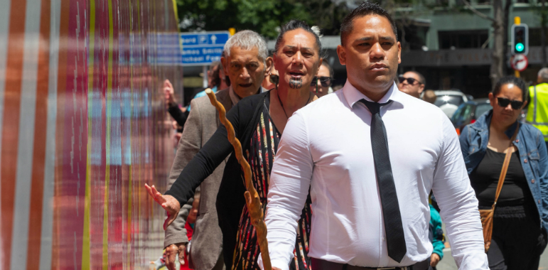 People walking alongside the civic precinct hoarding