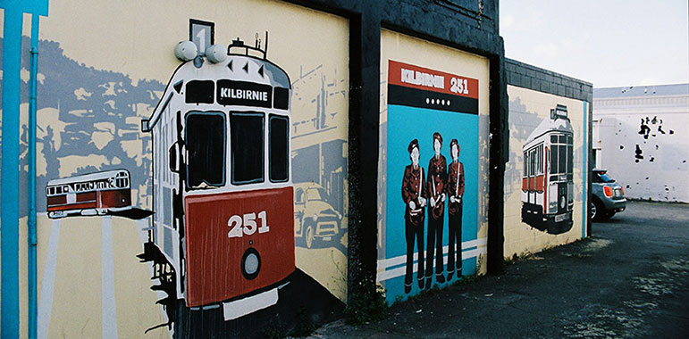 Trams and people standing in a group.