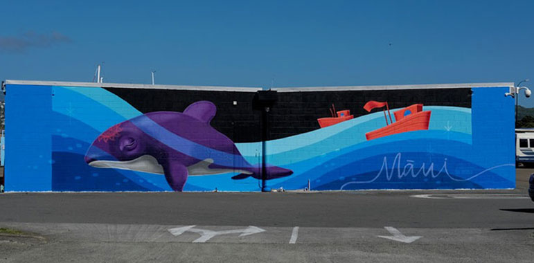 Mural showing dolphin, tug boats and 