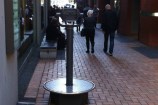 A sculpture made of pair of metal binoculars with electronic components looking down Chews Lane. 