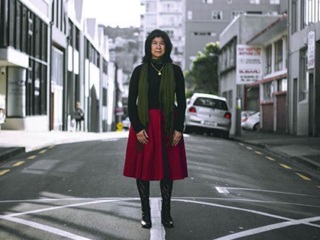 Chinese lady standing in the middle of a Wellington street.