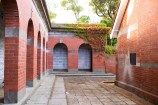 Two walls of memorial plaques in an outside area,