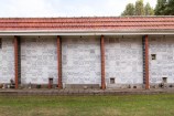 A wall of white memorial niches that look like tiles.