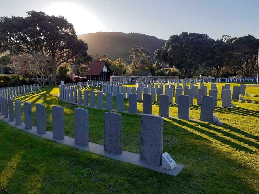 Rows of grey headstones in a line.