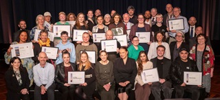 Group photo of the community awards winners posing with their certificates, as well as councillors.
