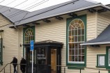 The front of the Newtown Community and Cultural Centre, a large wooden building with large windows.