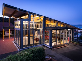 The Kelburn Terminus light up with lights inside with a dusky background.