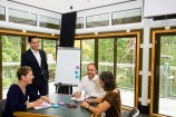 People having a meeting in the Treehouse seminar room.