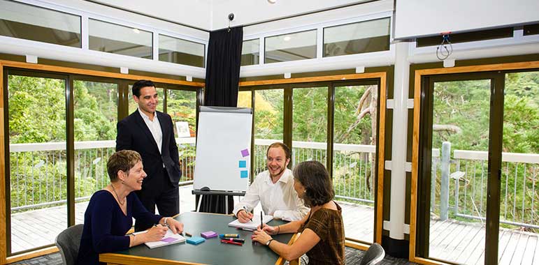 People having a meeting in the Treehouse seminar room.