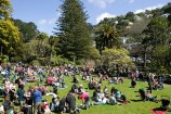 Crowd sitting on The Soundshell lawn.
