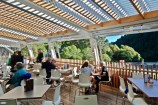 Picture of a cafe with customers sitting around tables.