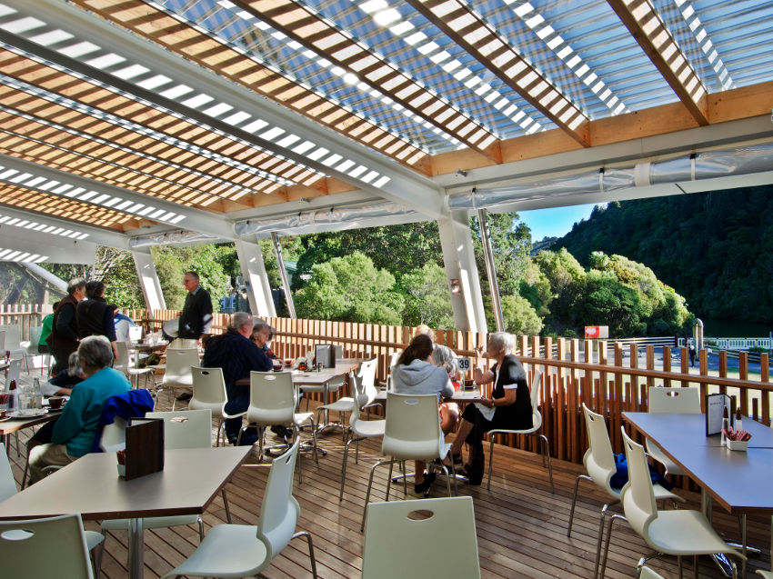 Picture of a cafe with customers sitting around tables.