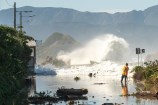 A large wave crashes onto Ōwhiro Bay during an extreme weather event.