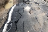 A landslide on a residential road during a weather event.