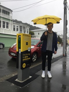 Image of EV car owner using charger on Austin Street