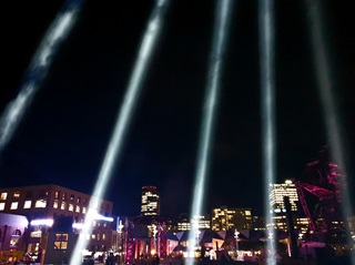 Matariki's Tūrama light sculpture lighting up the dark sky above the Wellington waterfront at Taranaki wharf.