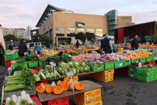 Image of bright fresh fruit and vegetables at the Harbourside Market on Wellington waterfront, with Te Papa in the background.