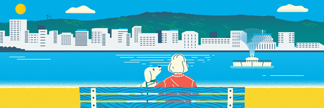 Woman and dog sitting at a bench at Oriental Bay.