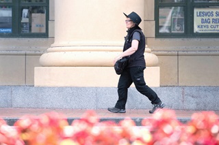 Parking warden Abra walking along a city street.