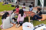 A table of children playing with playdough at a low table.