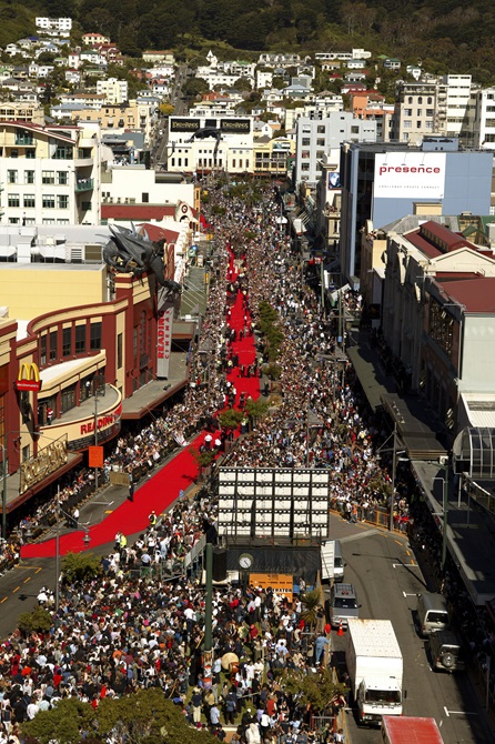 A birds eye view looking down Courtenay Place towards the Embassy Theatre, with crowds of people and the red carpet laid out down the main road for the opening of Lord of the Rings.