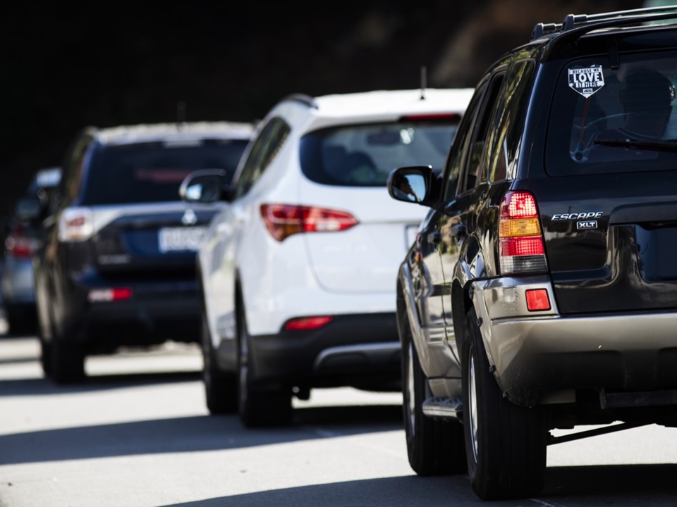 Cars on the road on a sunny day.