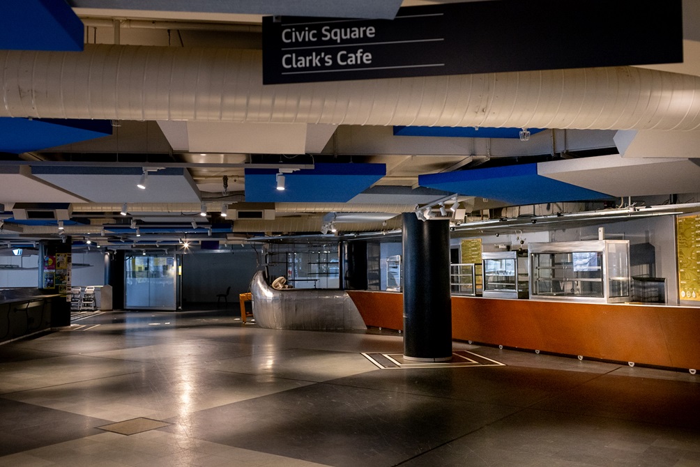 Clark's cafe in the Central Library completely empy with no furniture and dimmed lights.