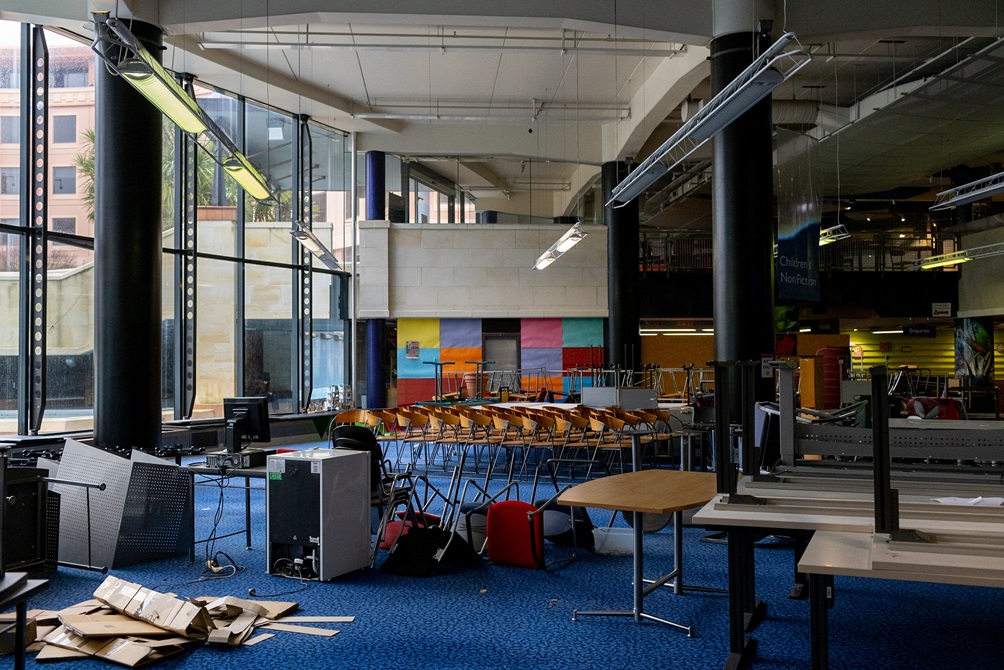 Chairs, tables and desks stacked on top of each other in the Central Library ground level floor.