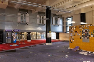 The old music section of the Central Library with no furniture or shelves and old CD cases still hanging on the walls.