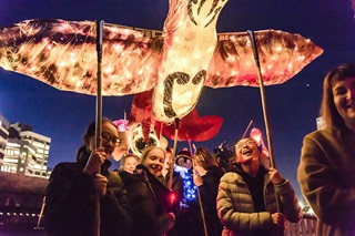 Image of young people with lanterns during Ahi Ka festival