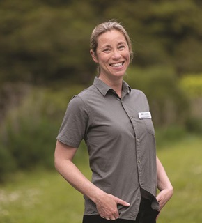 Lorraine Boennic smiling and standing in a green park.