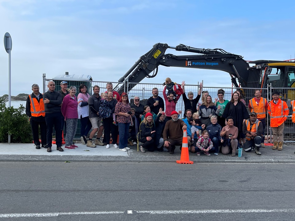 Residents of Owhiro Bay with contractors and digger as work due to start