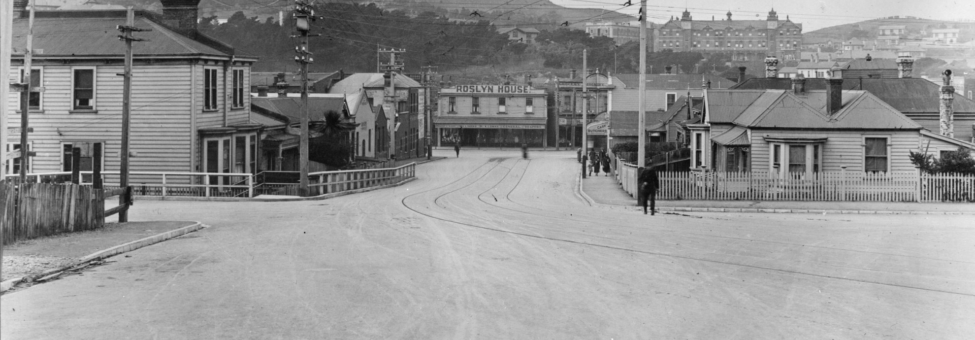 A black and white photo of Donald Street with visible tram tracks on the road and old wooden houses.