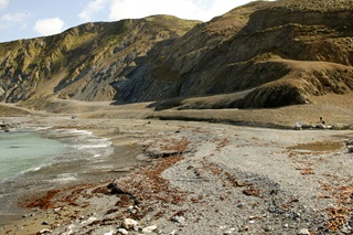The gravel road and beach near the entrance to Red Rocks Pariwhero.