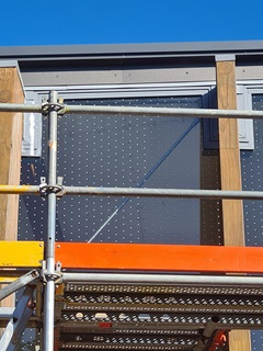 Cable Car decals being installed with scaffolding around terminal