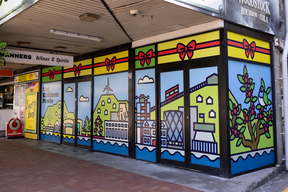 The outside of the new community centre on Manners Street with a colourful decal covering all the windows. 