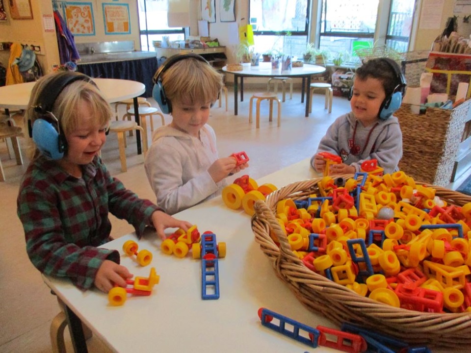 Aro Valley preschool children in earmuffs playing