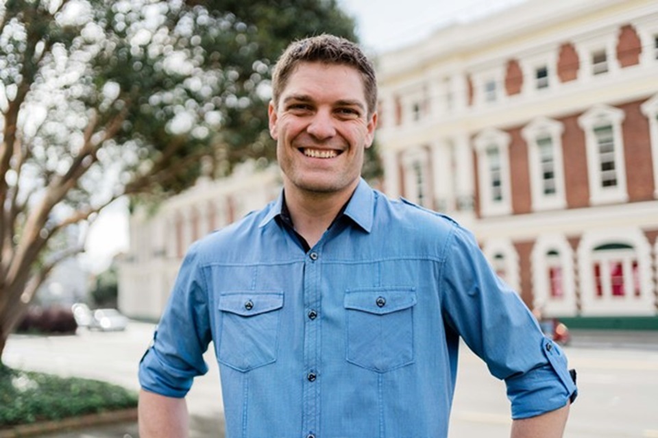 James Fuller standing in front of the Fine Arts building.