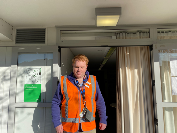 Man standing infront of a doorway.