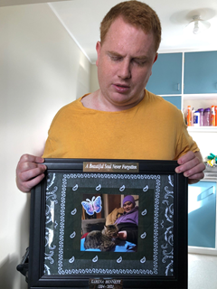 Man holding a photoframe.