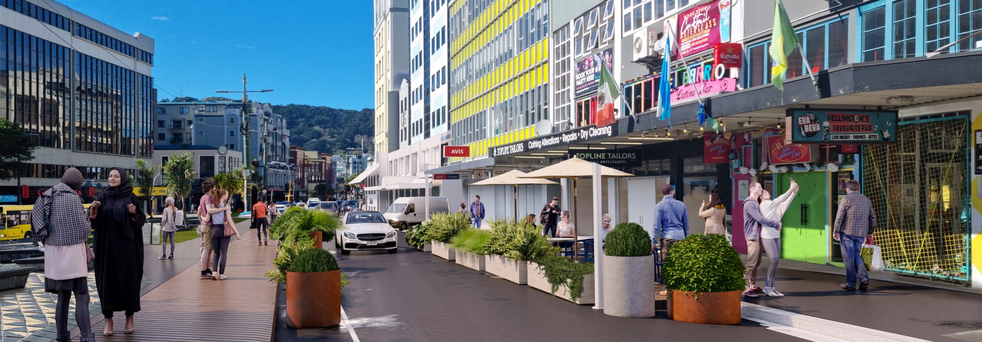 A street with buildings on one side and a park on the other.