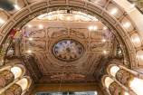 The inner circular roof of the St James Theatre with intricate painted details and lighting. 
