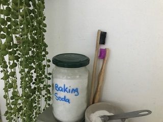 A jar and two toothbrushes.