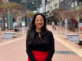 Woman standing on the street and smiling.