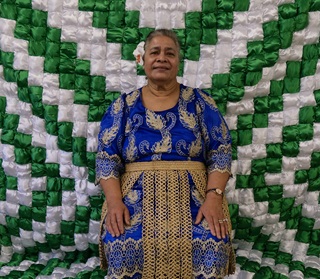 Woman standing infront of her artwork.